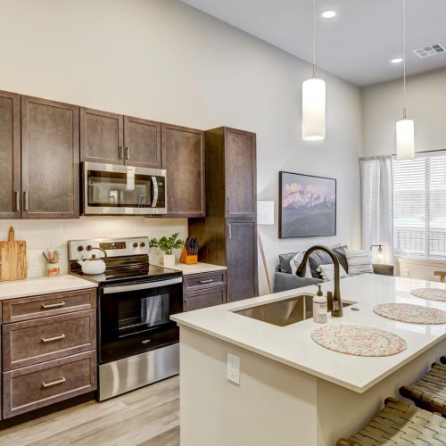 Beautiful kitchens with designer finishes a kitchen with an island and chairs