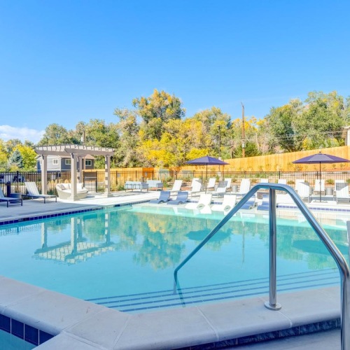 Resort-style swimming pool a swimming pool with a building in the background